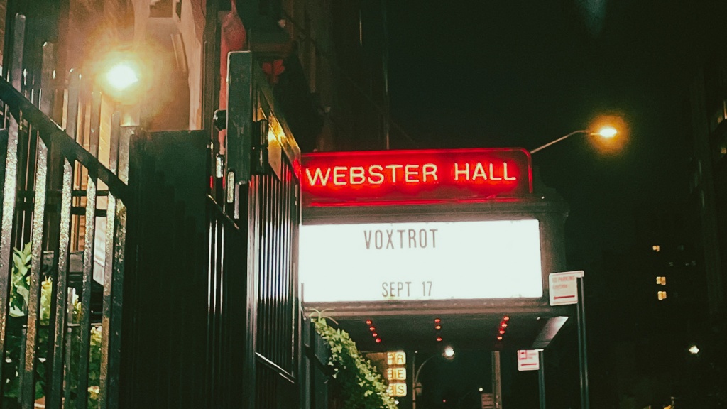 Taken at night, a lit-up billboard bears the name Webster Hall in all uppercase. Beneath it, a band's name Voxtrot and the date of their concert, September 17.